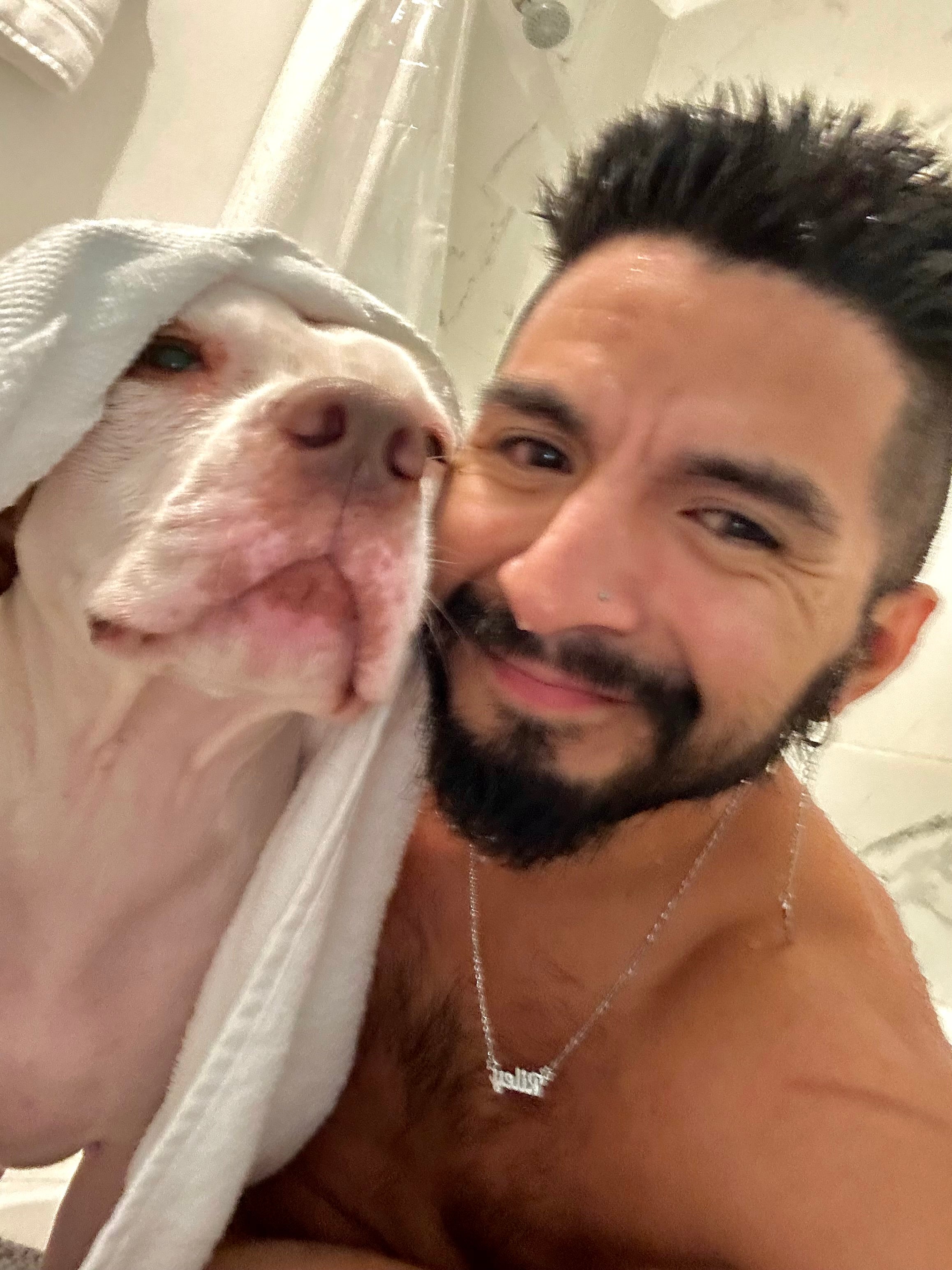 Roberto giving Riley Grace an at-home dog bath in Houston