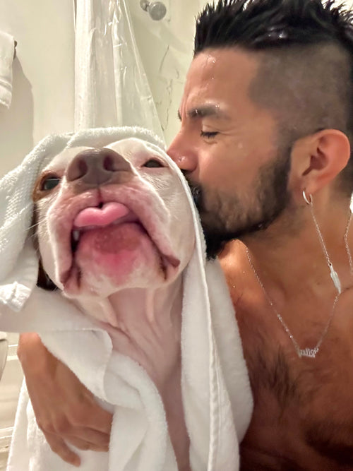 Roberto giving Riley Grace an at-home dog bath in Houston