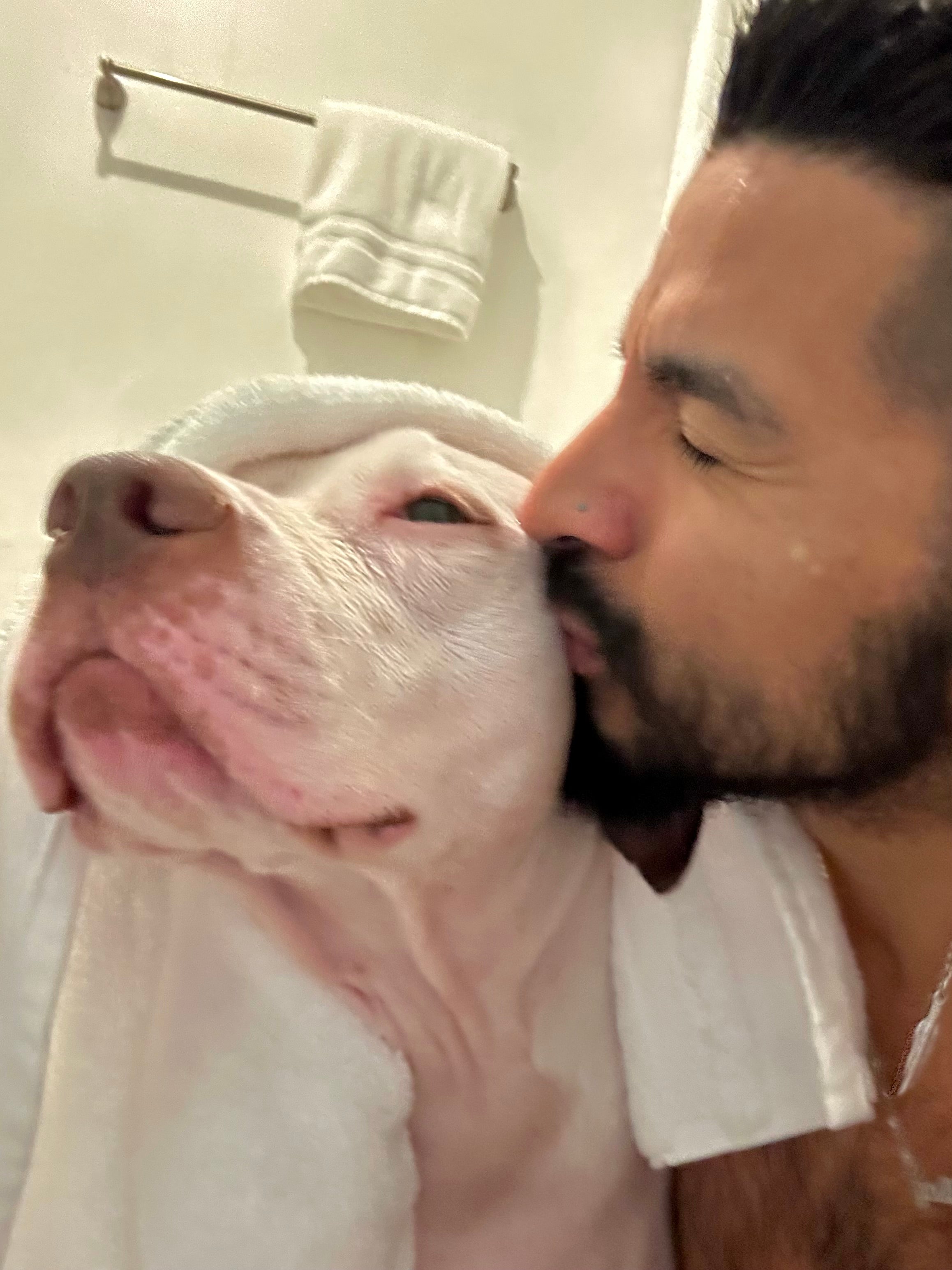 Roberto giving Riley Grace an at-home dog bath in Houston